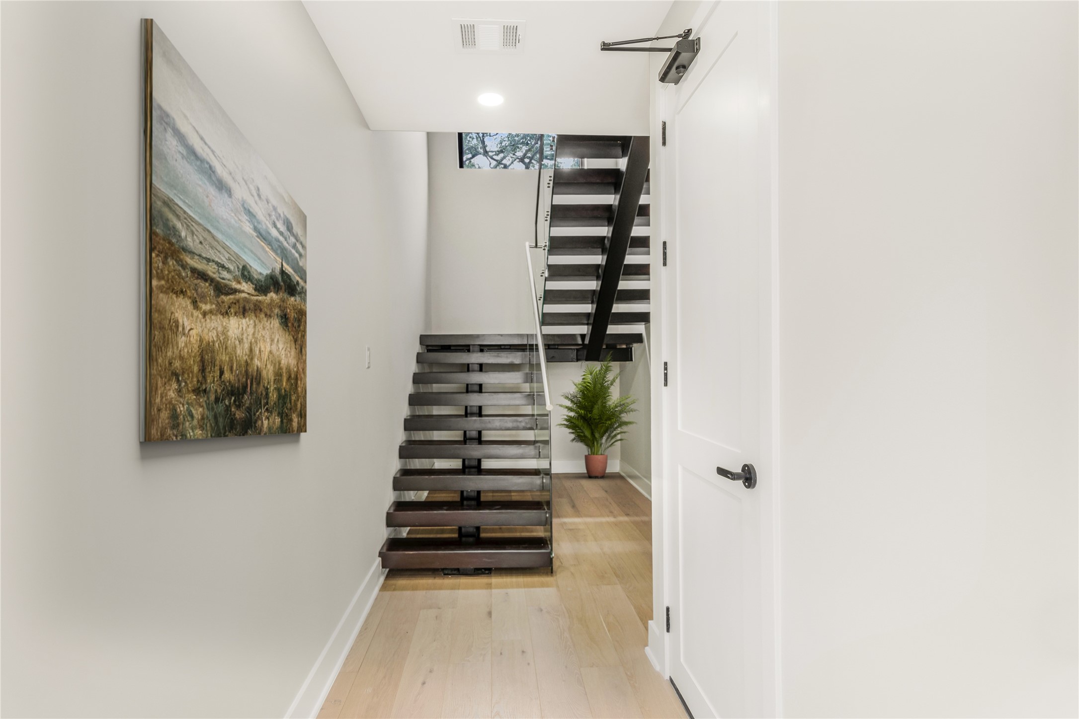 2237 Blalock Road Houston, TX 77080 - Photo 3 of 33 a view of a hallway with stairs and wooden floor