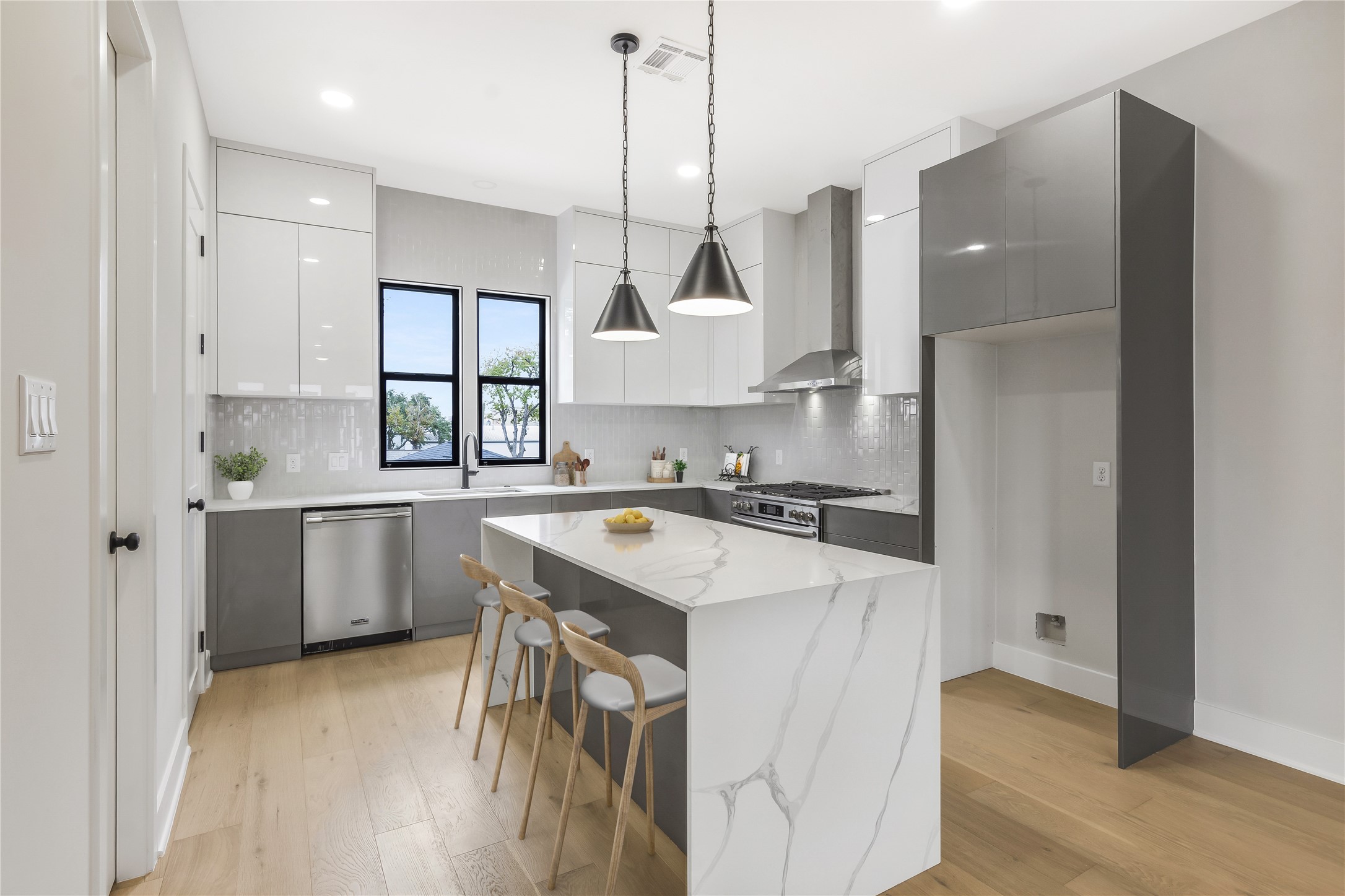 2237 Blalock Road Houston, TX 77080 - Photo 7 of 33 a kitchen with a stove a sink a window and stainless steel appliances