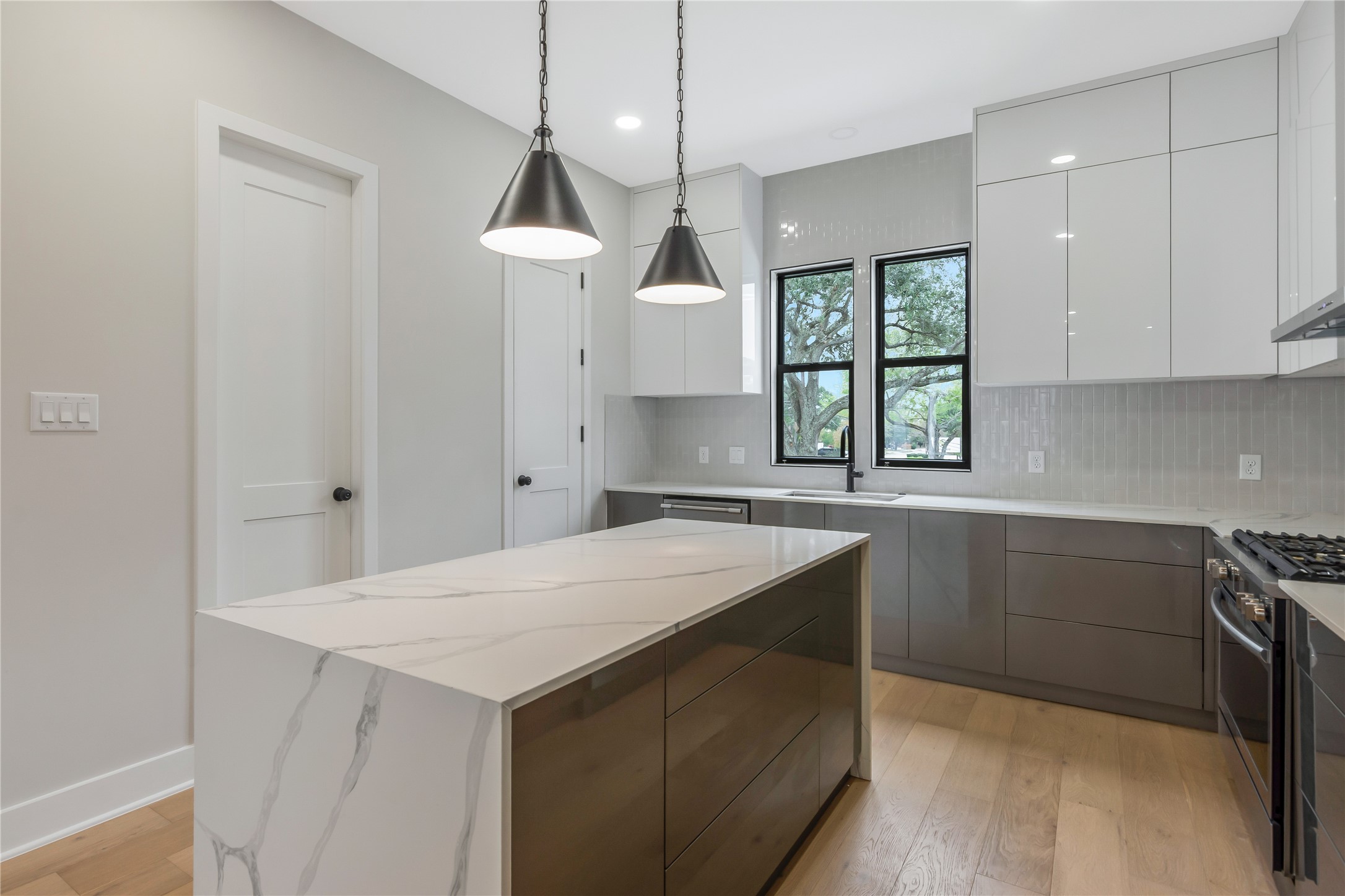 2237 Blalock Road Houston, TX 77080 - Photo 9 of 33 a kitchen with a stove a sink and a window