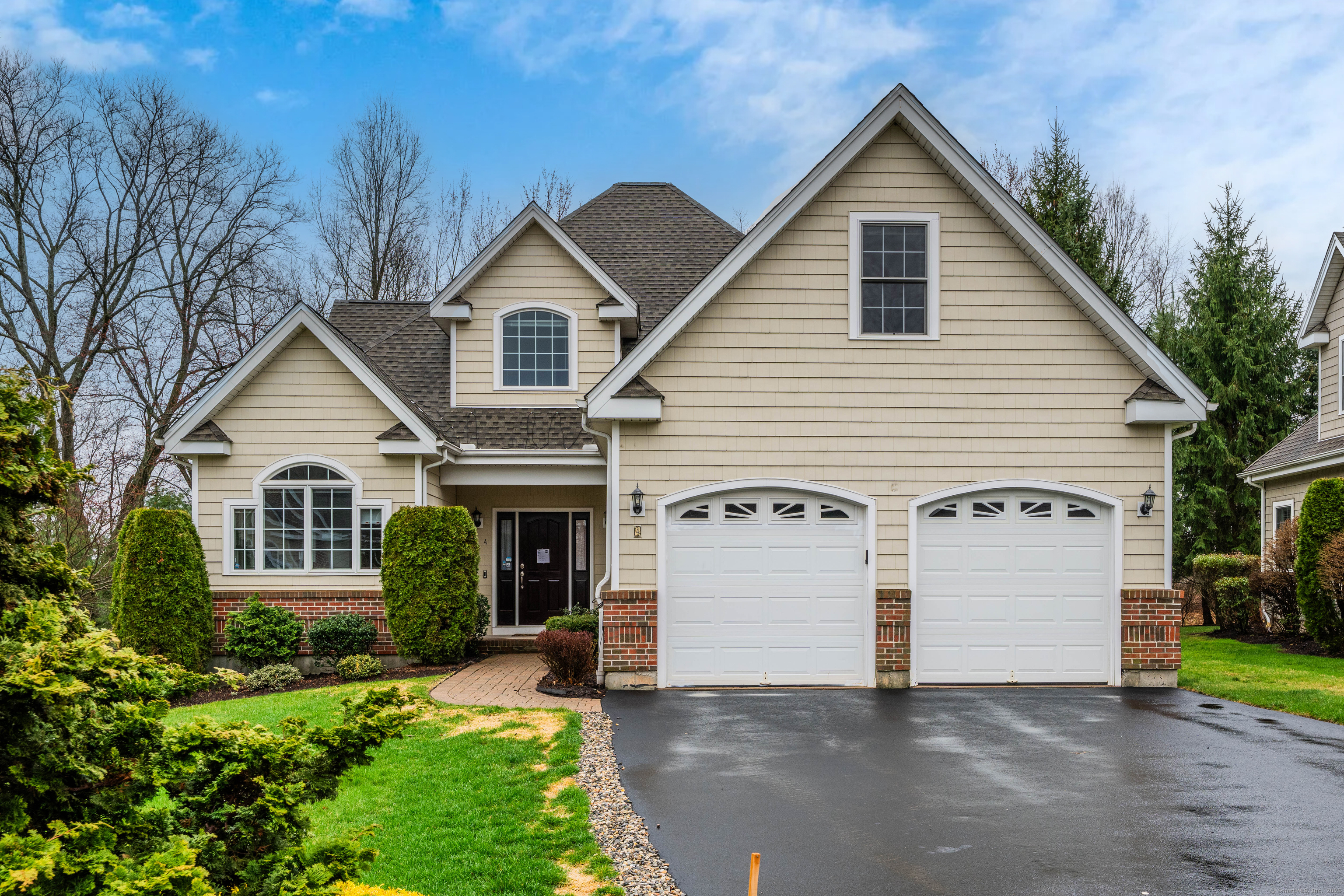 a view of house with a yard and potted plants