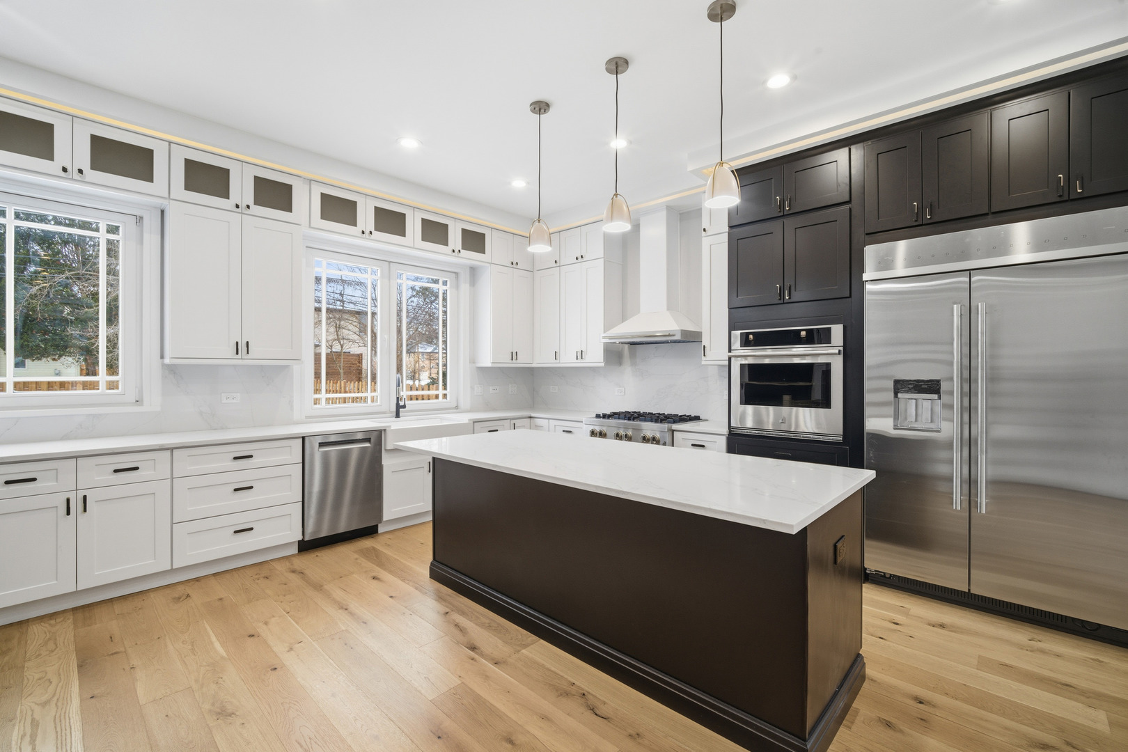 38 Washington Street Glenview, IL 60025 - Photo 4 of 27 a kitchen with stainless steel appliances kitchen island granite countertop a refrigerator a sink and a stove