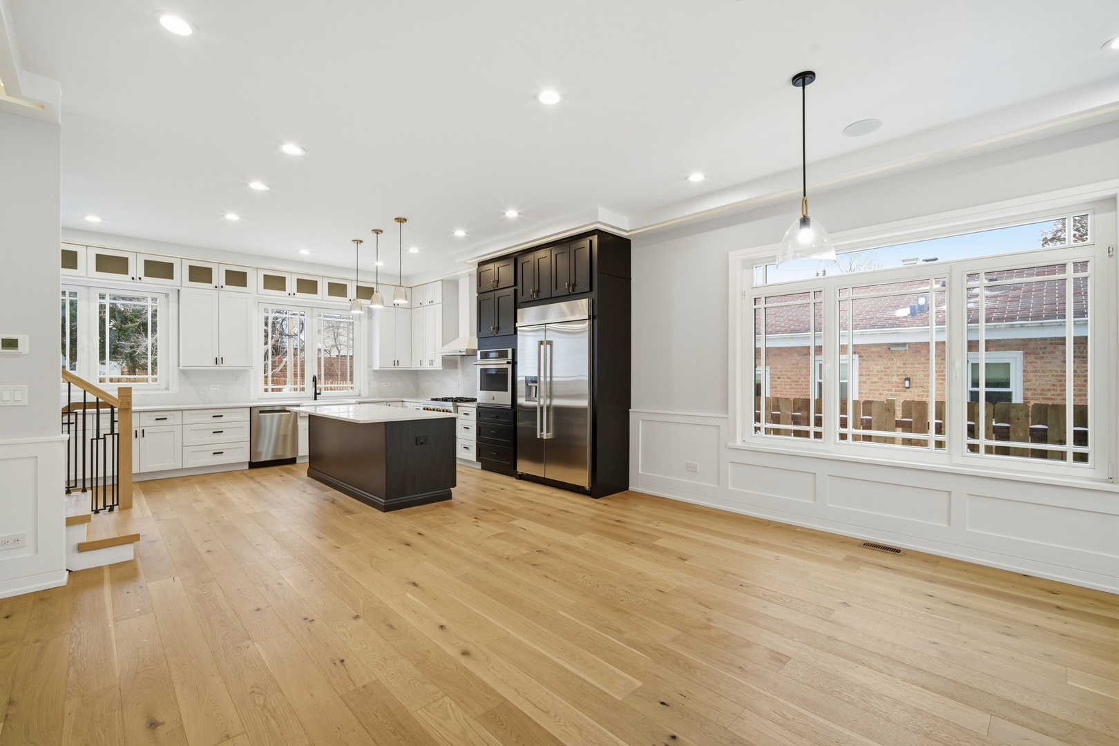 38 Washington Street Glenview, IL 60025 - Photo 5 of 27 a large kitchen with a large counter top a sink stainless steel appliances and cabinets