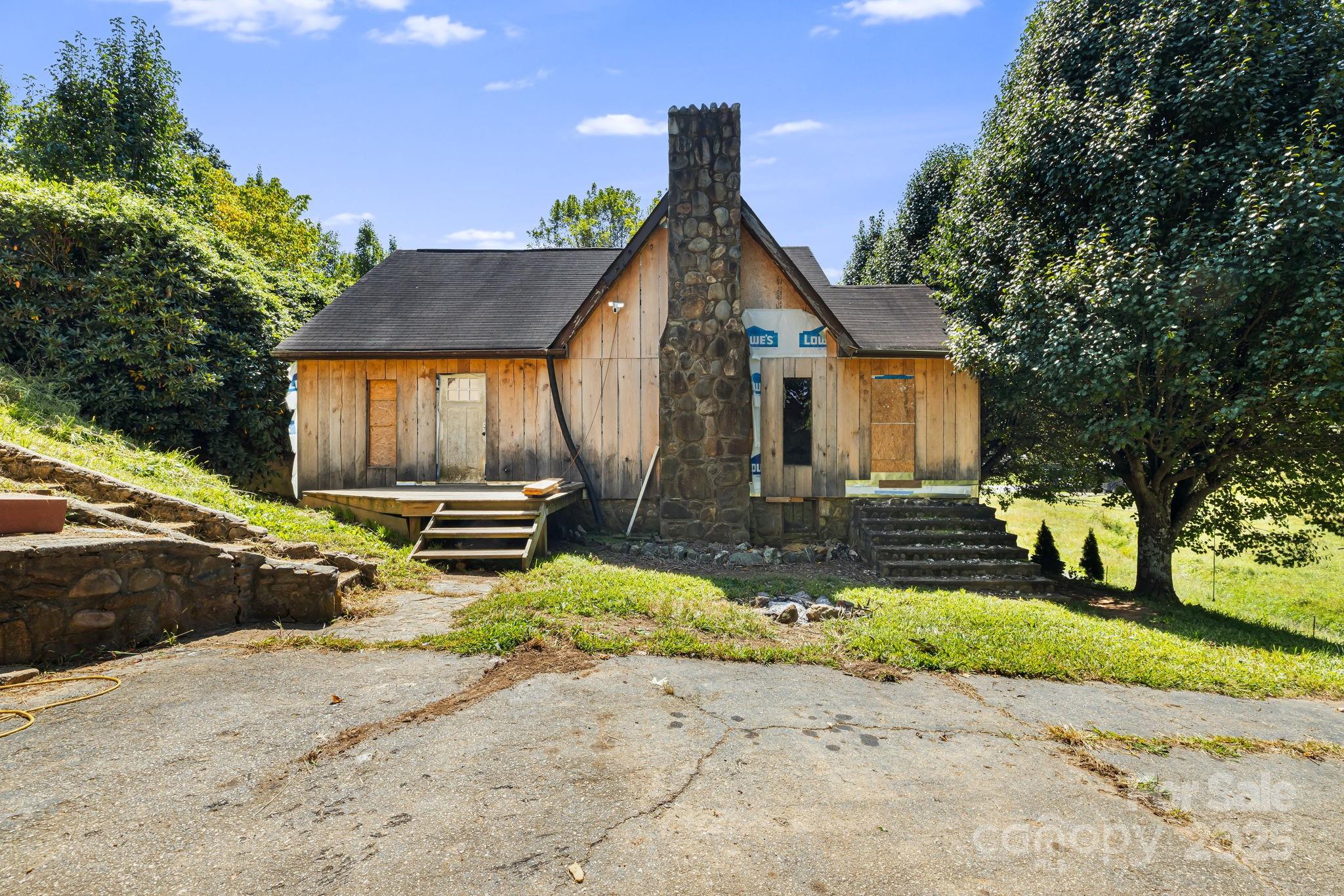 1277 Henson Cove Road Canton, NC 28716 - Photo 4 of 21 a front view of a house with a yard