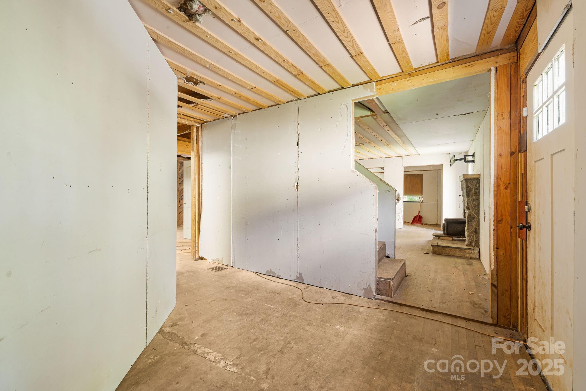 1277 Henson Cove Road Canton, NC 28716 - Photo 6 of 21 a view of a hallway with wooden shelves