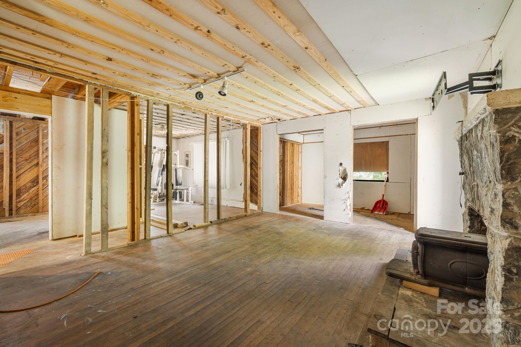1277 Henson Cove Road Canton, NC 28716 - Photo 7 of 21 a view of a room with wooden floor and furniture
