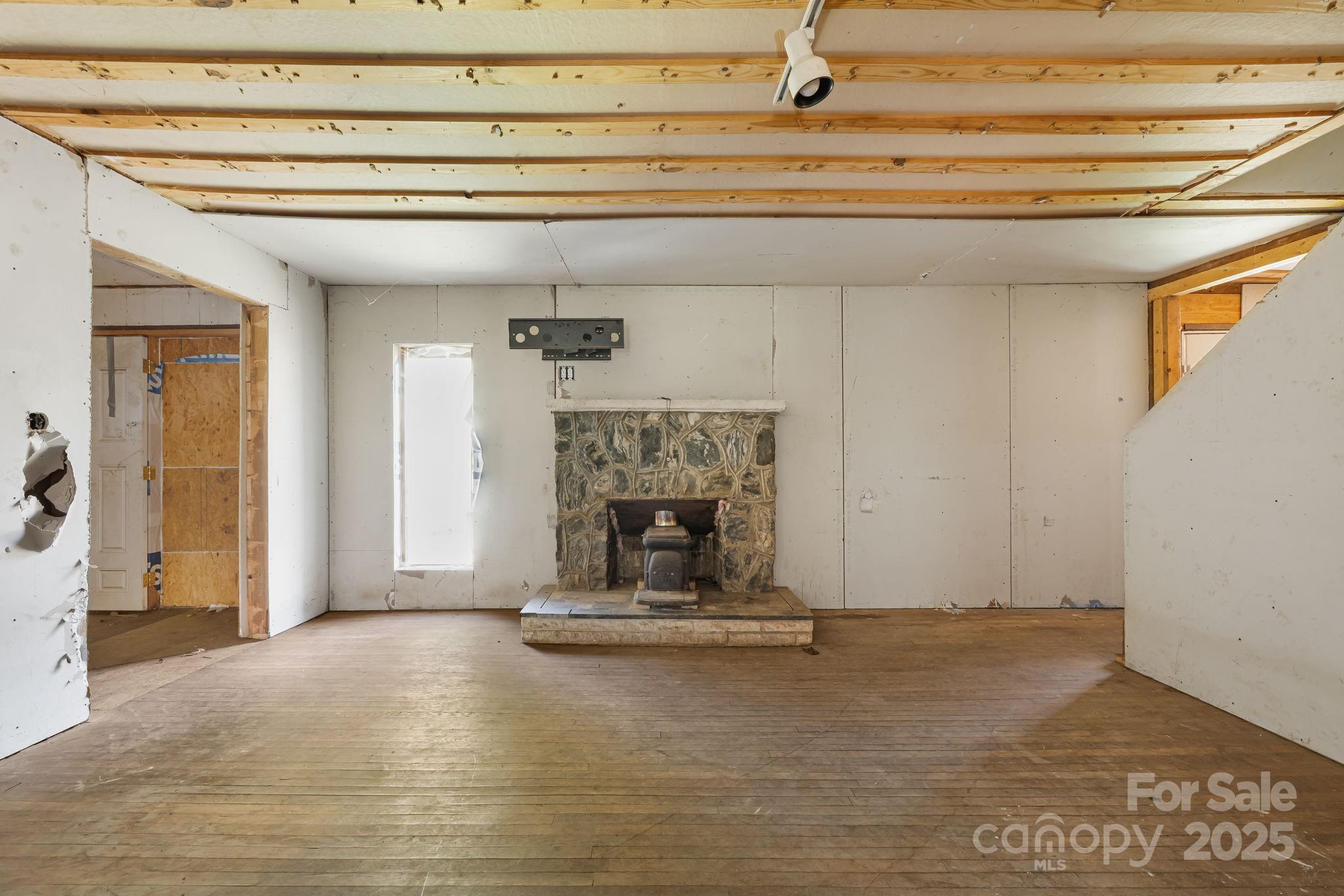 1277 Henson Cove Road Canton, NC 28716 - Photo 8 of 21 a view of fireplace and wooden floor