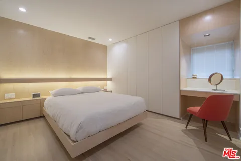 a bedroom with a bed and chair