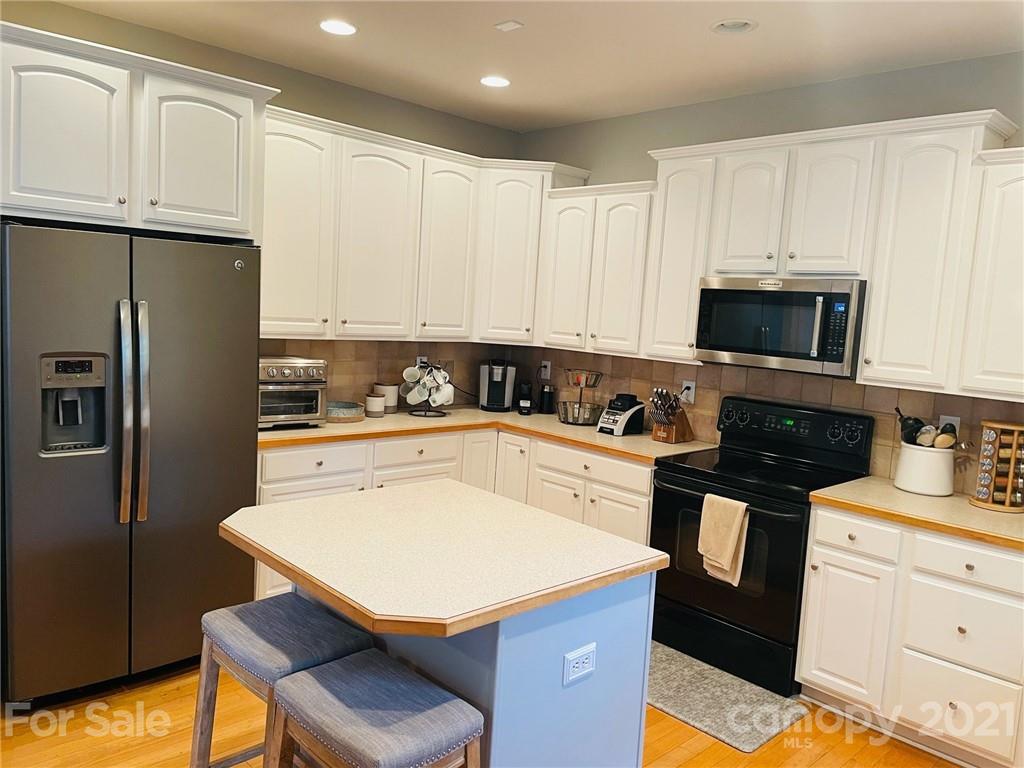 6008 Colton Ridge Drive Indian Trail, NC 28079 - Photo 12 of 14 a kitchen with stainless steel appliances a stove refrigerator sink and cabinets
