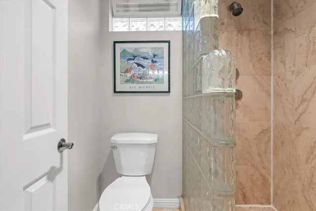 a white toilet sitting next to a bathroom sink