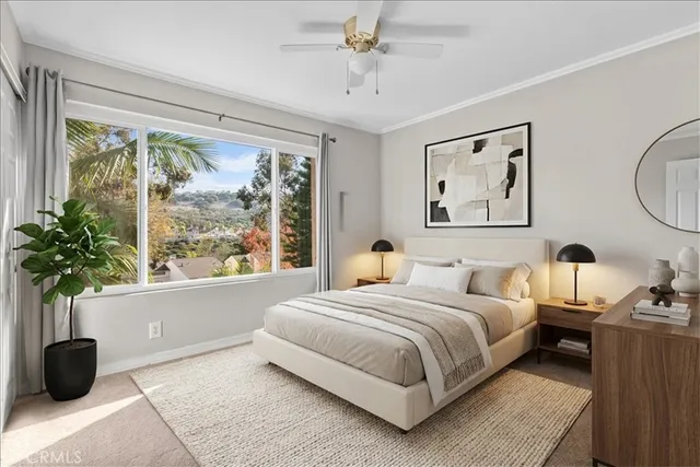 a bedroom with a bed and a large window