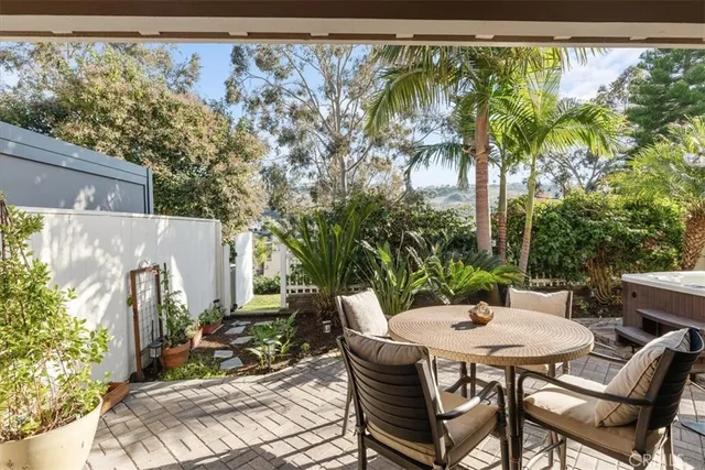 a view of a patio with table and chairs and potted plants