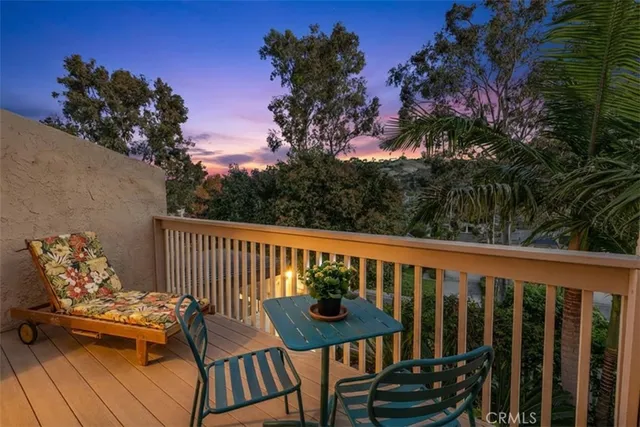 a view of a roof deck with wooden floor and outdoor seating