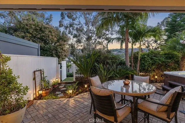 a view of a patio with table and chairs and potted plants