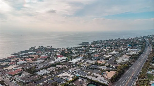 an aerial view of a city with ocean