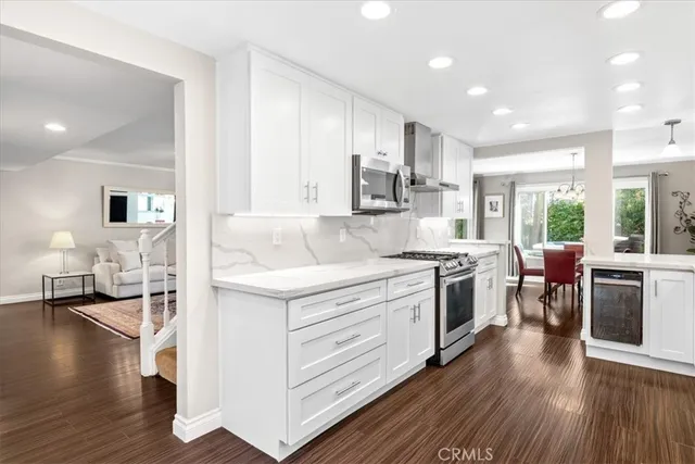 a kitchen with a sink stove and wooden cabinets