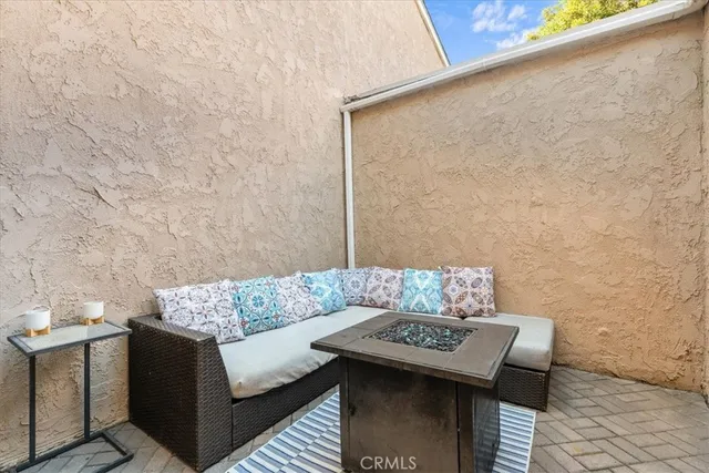 a couch sitting in a living room next to a brick wall