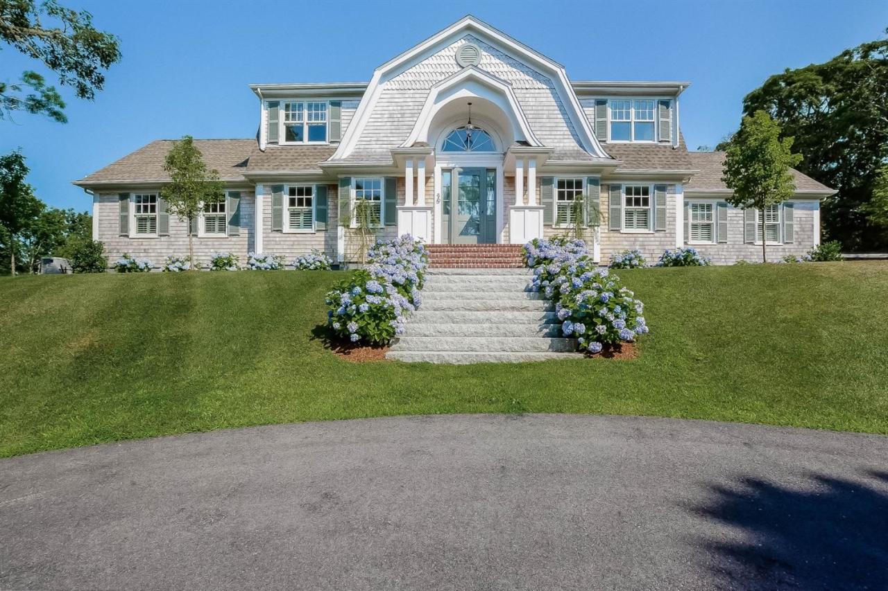 a front view of a house with a garden