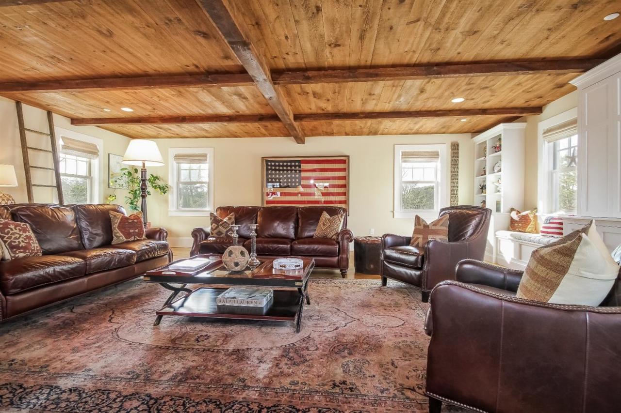 56 Sears Road Chatham, MA 02633 - Photo 13 of 14 a living room with furniture and a chandelier