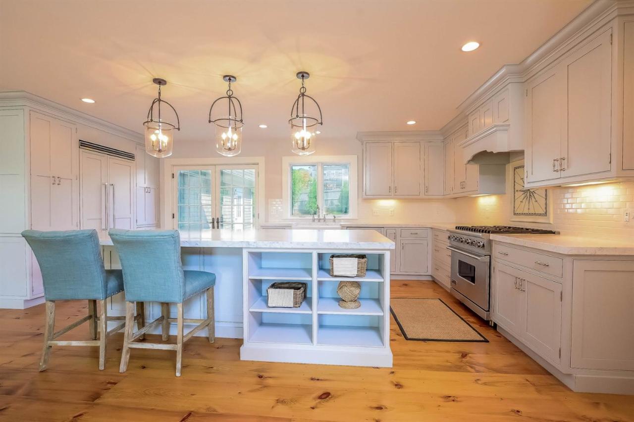 56 Sears Road Chatham, MA 02633 - Photo 5 of 14 a kitchen with stainless steel appliances kitchen island granite countertop a table chairs in it and a window