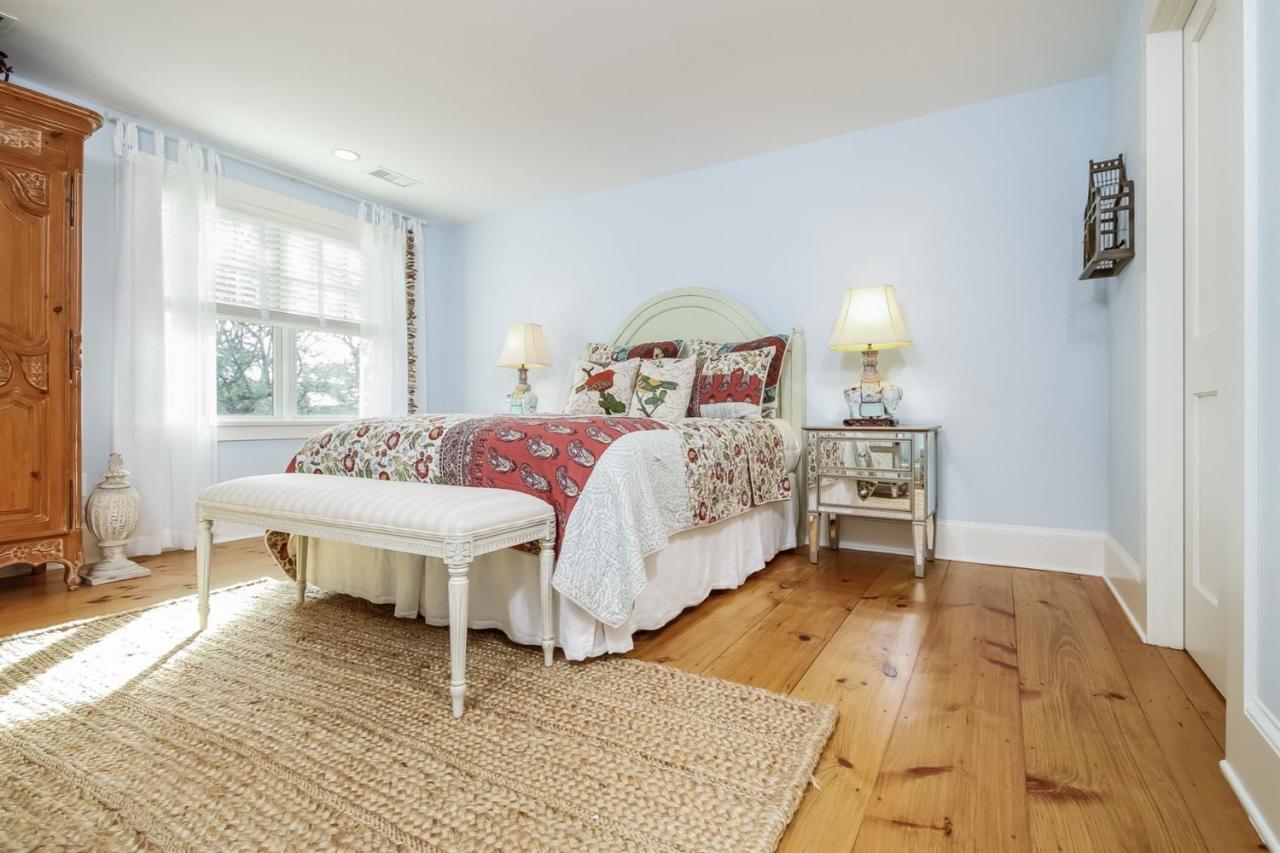 56 Sears Road Chatham, MA 02633 - Photo 9 of 14 a bedroom with a bed and a table in it