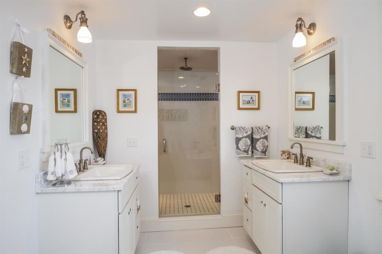 56 Sears Road Chatham, MA 02633 - Photo 10 of 14 a bathroom with double vanity sink and a mirror