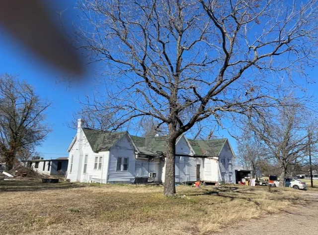 a view of a large house with a large tree