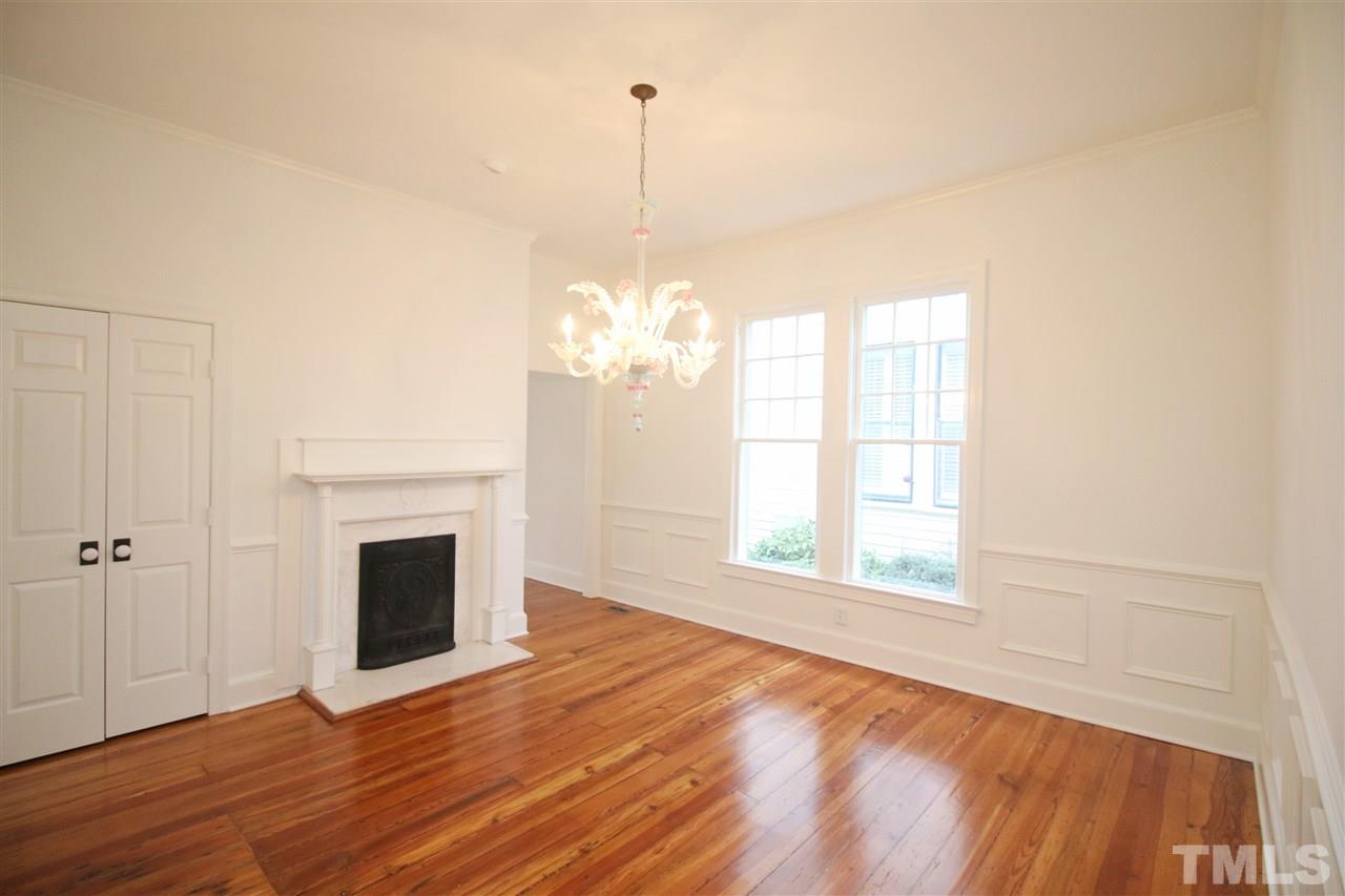 407 Polk Street Raleigh, NC 27604 - Photo 11 of 25 a view of a livingroom with a chandelier a fireplace and wooden floor