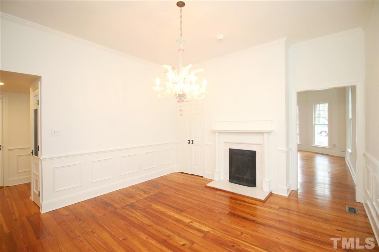 407 Polk Street Raleigh, NC 27604 - Photo 12 of 25 a view of empty room with wooden floor and fireplace
