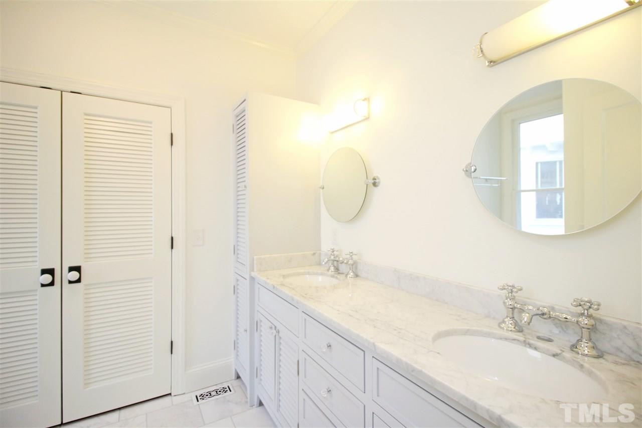 407 Polk Street Raleigh, NC 27604 - Photo 14 of 25 a bathroom with a granite countertop sink and a mirror