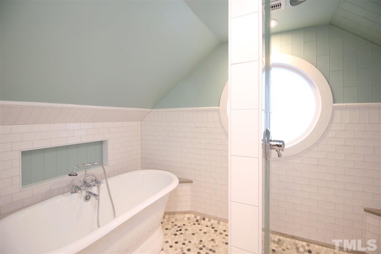 407 Polk Street Raleigh, NC 27604 - Photo 21 of 25 a bathroom with a tub sink and mirror