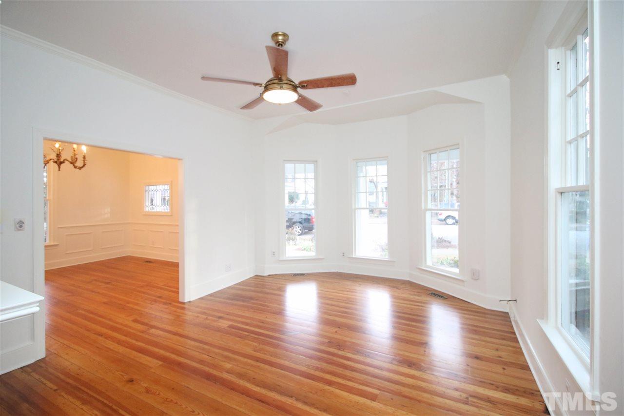 407 Polk Street Raleigh, NC 27604 - Photo 6 of 25 a view of an empty room with wooden floor and a window
