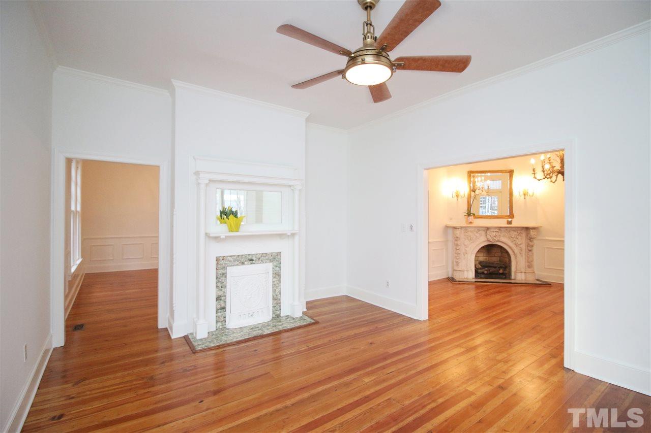 407 Polk Street Raleigh, NC 27604 - Photo 7 of 25 a view of a hallway with wooden floor and a workspace