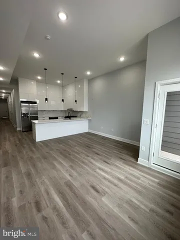 a large kitchen with cabinets and stainless steel appliances