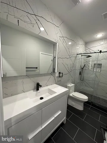 a bathroom with a toilet and shower
