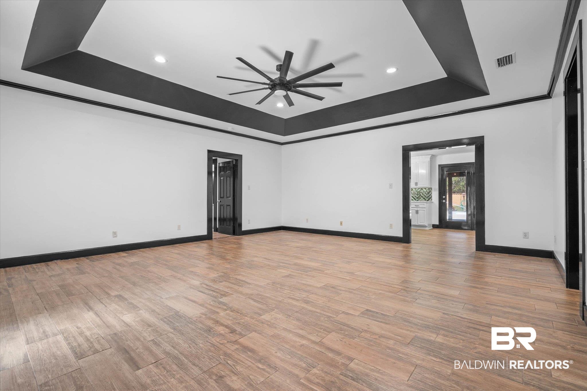 3216 Bay Booster Club Road Theodore, AL 36582 - Photo 2 of 46 Empty room with light wood finished floors, a ceiling fan, a tray ceiling, recessed lighting, and ornamental molding