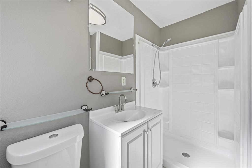 13485 Liberty School Road, Unit 1 Azle, TX 76020 - Photo 12 of 21 a bathroom with a sink toilet vanity and shower