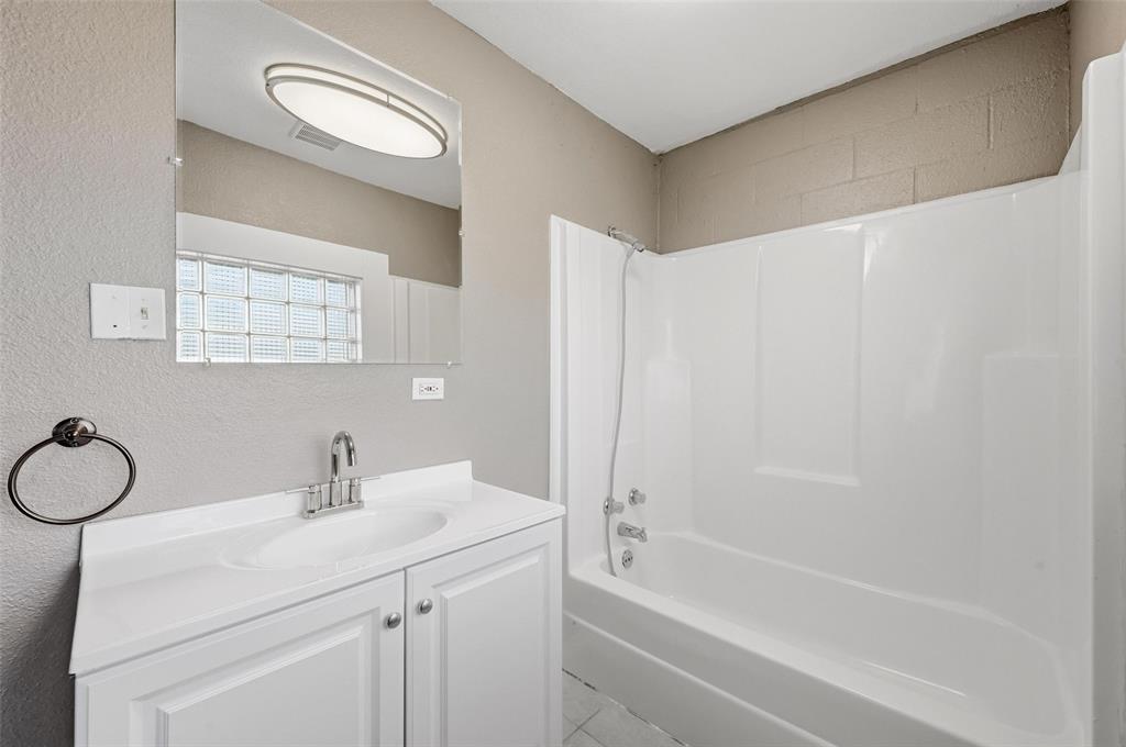 13485 Liberty School Road, Unit 1 Azle, TX 76020 - Photo 16 of 21 a bathroom with a sink a toilet and shower