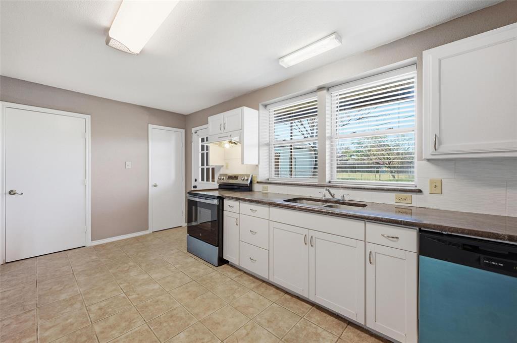 13485 Liberty School Road, Unit 1 Azle, TX 76020 - Photo 9 of 21 a kitchen with stainless steel appliances granite countertop a sink and a window