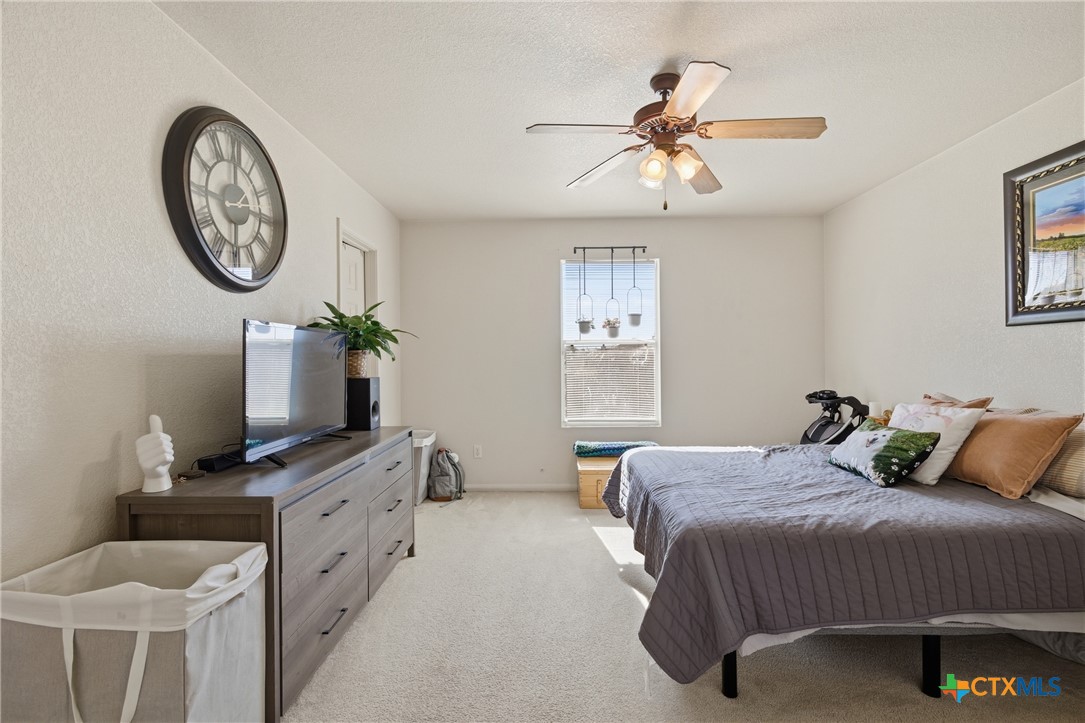 3310 Bull Run Drive Killeen, TX 76549 - Photo 11 of 27 a bedroom with a bed and a chandelier