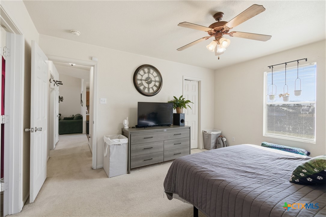 3310 Bull Run Drive Killeen, TX 76549 - Photo 12 of 27 a bedroom with a bed and a chandelier