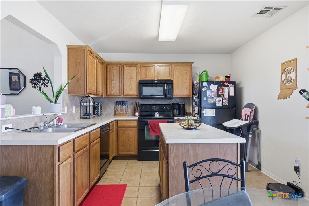 3310 Bull Run Drive Killeen, TX 76549 - Photo 8 of 27 a kitchen with a stove a sink and a refrigerator