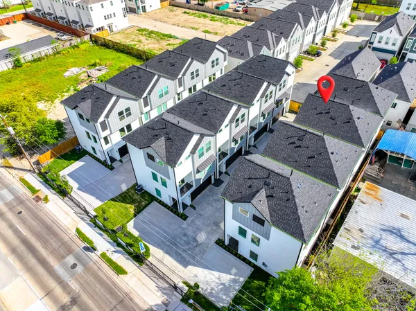 an aerial view of a house with a garden and swimming pool
