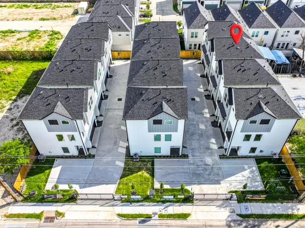 an aerial view of multiple houses with outdoor space