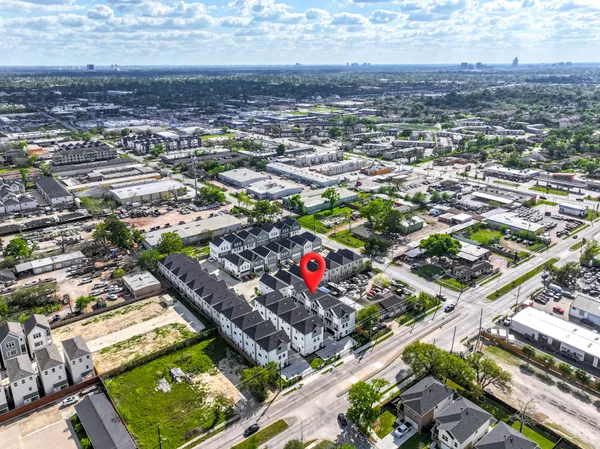 an aerial view of residential houses with city view