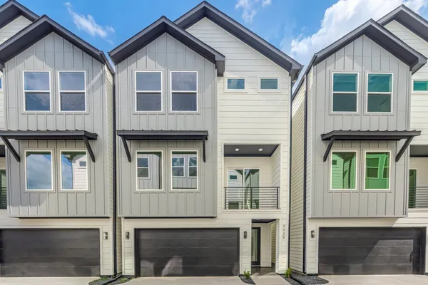 a view of residential houses with large windows