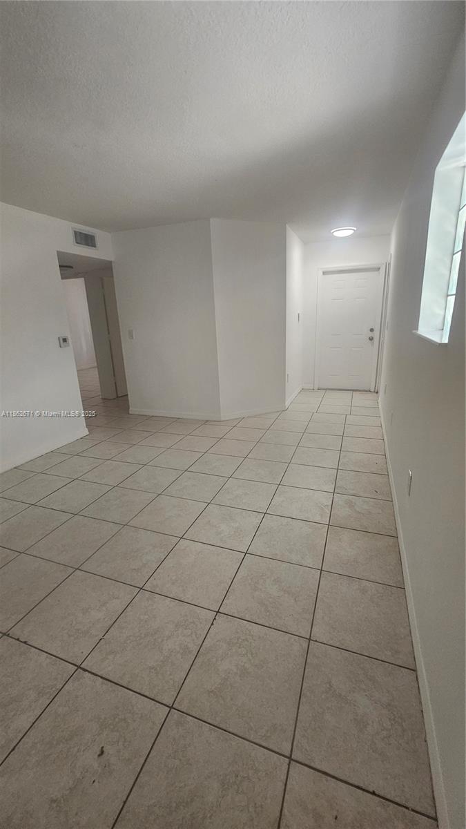 1301 Southeast 28th Lane, Unit 10142 Homestead, FL 33035 - Photo 5 of 9 a view of an empty room and window