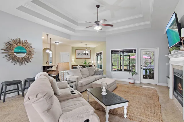 a living room with furniture a fireplace and a flat screen tv
