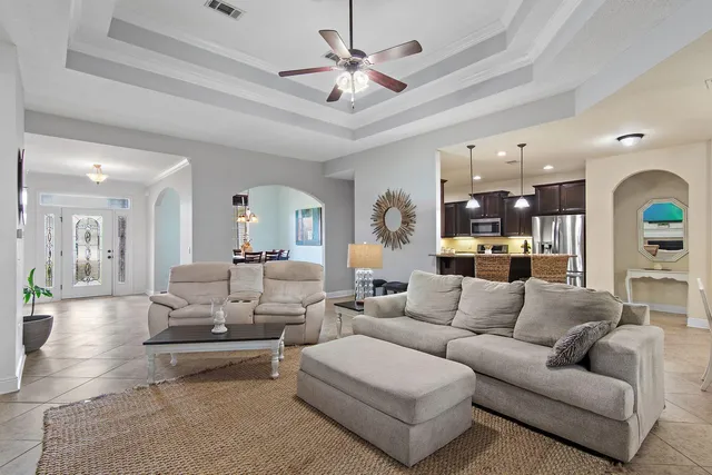 a living room with furniture ceiling fan and a rug