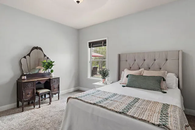 a bedroom with a bed and a table