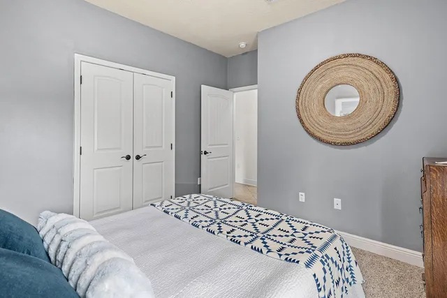 a bedroom with a bed and a lamp